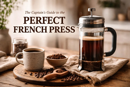 A rustic wooden table with a stainless steel French Press and a bag of Privateer Coffee Co small-batch beans.